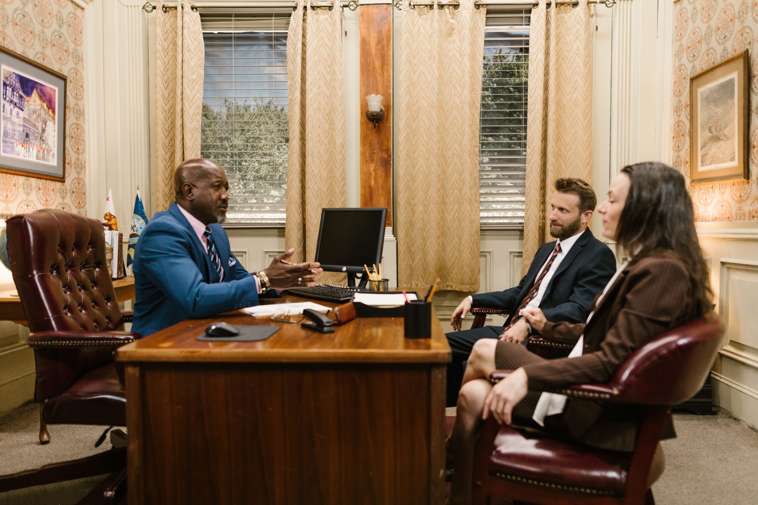 Lawyers discussing with a client in a professional office environment