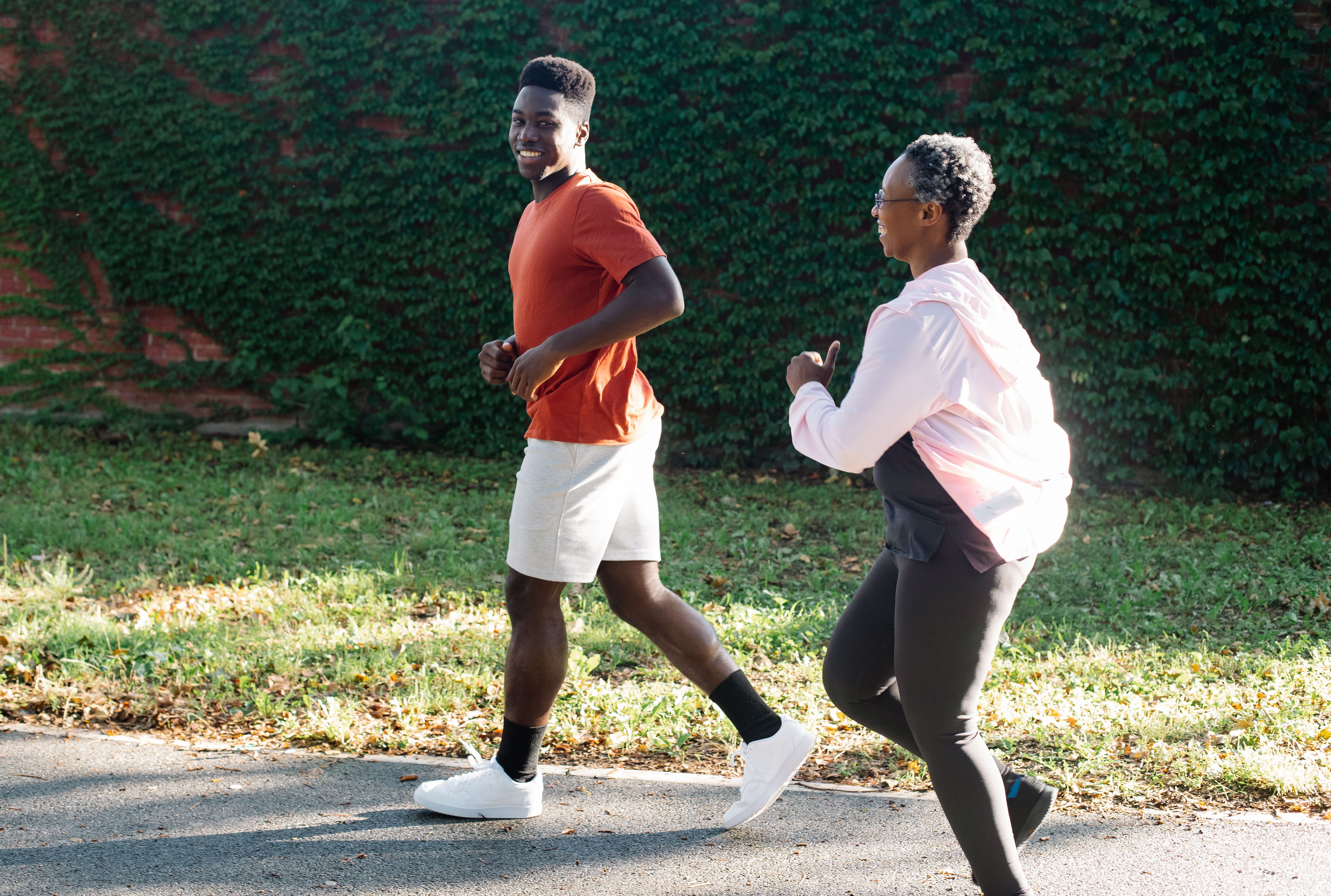 A couple jogging outdoors, evoking cardiovascular fitness and the active side of sexual wellness.